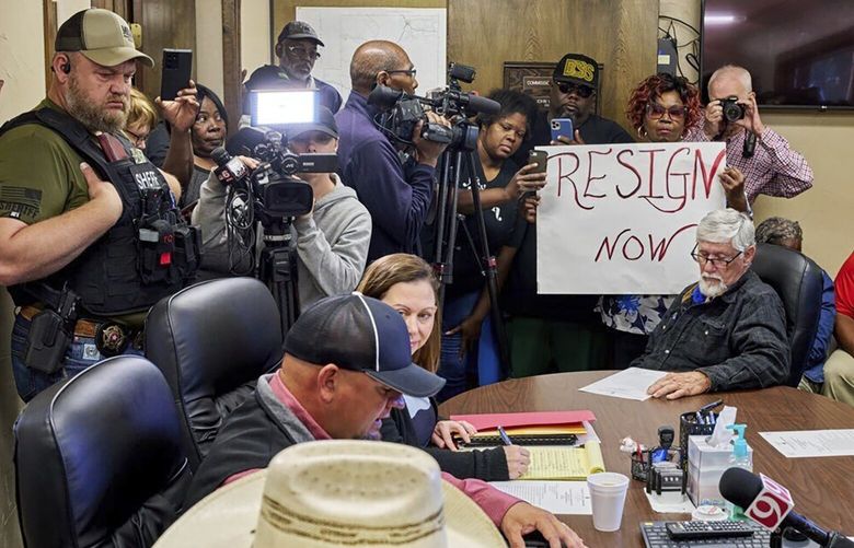 In this photo provided by the Southwest Ledger, people from Idabel, Okla., call for the resignation of several McCurtain County officials at a county commissioners meeting early Monday, April 17, 2023, after tapes with the officials’ racist comments surfaced over the weekend. (Christopher Bryan/Southwest Ledger via AP) NYSB103 NYSB103