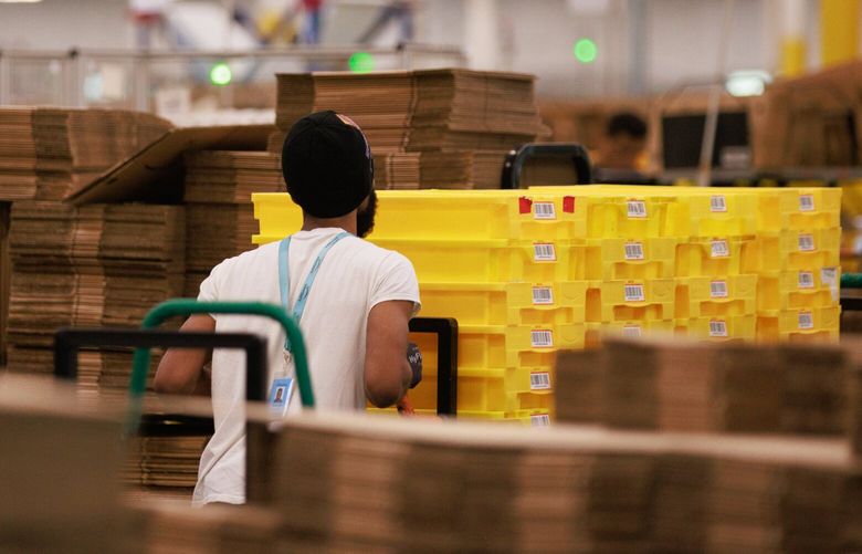 Amazon employees work inside Amazon’s Kent fulfillment center in Kent Wash. Friday, July 22, 2022. 221047