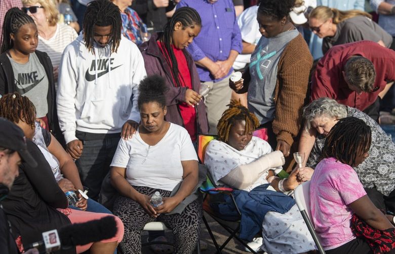 Shooting victim Taniya Cox prays with her family during a prayer vigil at First Baptist Church in Dadeville, Ala., on Sunday, April 16, 2023. A deadly shooting happened late Saturday night at Mahogany Masterpiece dance studio in downtown Dadeville. (Jake Crandall/The Montgomery Advertiser via AP) ALMON113 ALMON113