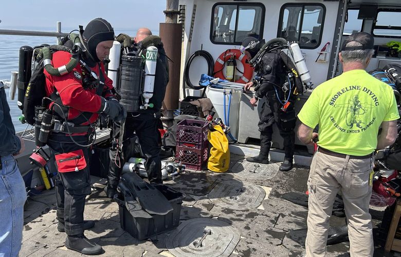 This photo, provided by Shoreline Diving Services, shows the team preparing to dive the wreck of the 92-foot attack submarine Defender, Friday, April 14, 2023, that was scuttled by the Army Corp of Engineers in 1946. The Defender was found Sunday, April 16, 2023. by a dive team led by Richard Simon, a commercial diver from Coventry, Connecticut. (Jennifer Sellitti/Shoreline Diving Services via AP) NYRD206 NYRD206