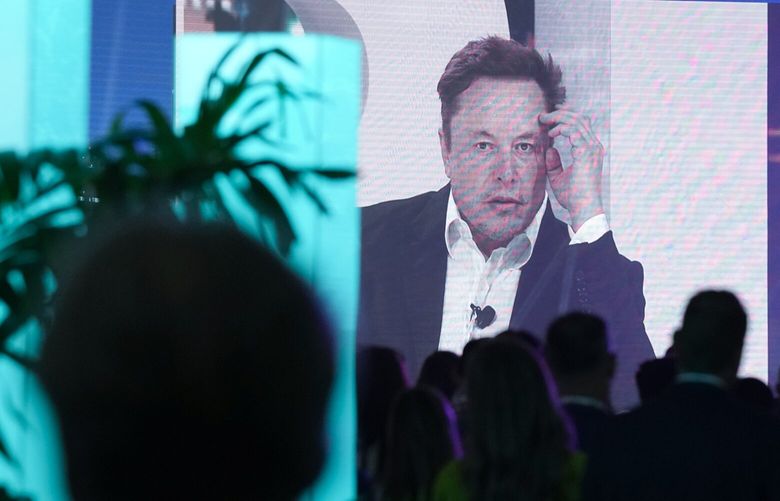 Twitter CEO Elon Musk is broadcast on a screen as he speaks at the POSSIBLE marketing conference, Tuesday, April 18, 2023, in Miami Beach, Fla. (AP Photo/Rebecca Blackwell) FLRB105 FLRB105