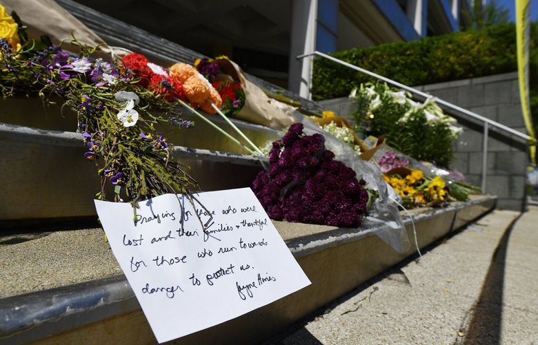 Flowers and a message of hope sit on the steps of the Old National Bank in Louisville, Ky., Tuesday, April 11, 2023. On Monday, a shooting at the bank located in downtown Louisville killed several people and wounded others. (AP Photo/Timothy D. Easley) KYTE111 KYTE111