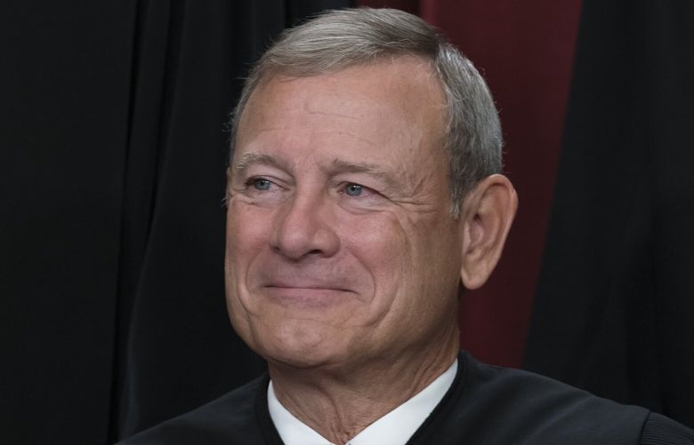 FILE – Chief Justice of the United States John Roberts joins other members of the Supreme Court as they pose for a new group portrait, at the Supreme Court building in Washington, Oct. 7, 2022. The Democratic chairman of the Senate Judiciary has invited Supreme Court Justice John Roberts to testify next month at a hearing on ethics standards. (AP Photo/J. Scott Applewhite, File) WX108 WX108