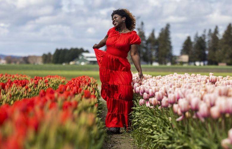 Joreal Mack poses for her friend Latalia Soutar taking pictures at Tulip Town in Skagit County on Wednesday, April 19, 2023.