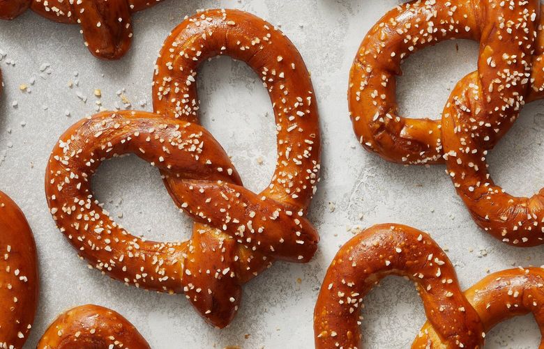 Soft pretzels in New York, March 30, 2023. Compared with a tricky loaf of sourdough, these classic treats aren’t hard to get right, and can similarly scratch the itch for a baking project. Food styled by Simon Andrews. (Kerri Brewer/The New York Times) XNYT79 XNYT79