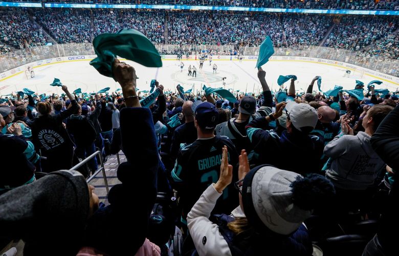 Fans celebrate a Seattle Kraken goal during the second period. 223573