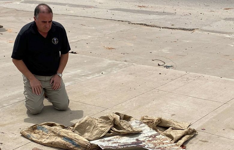 U.S. Ambassador Alexander Laskaris kneels on a bloodstained sidewalk in N’Djamena. MUST CREDIT: U.S. Embassy N’Djamena