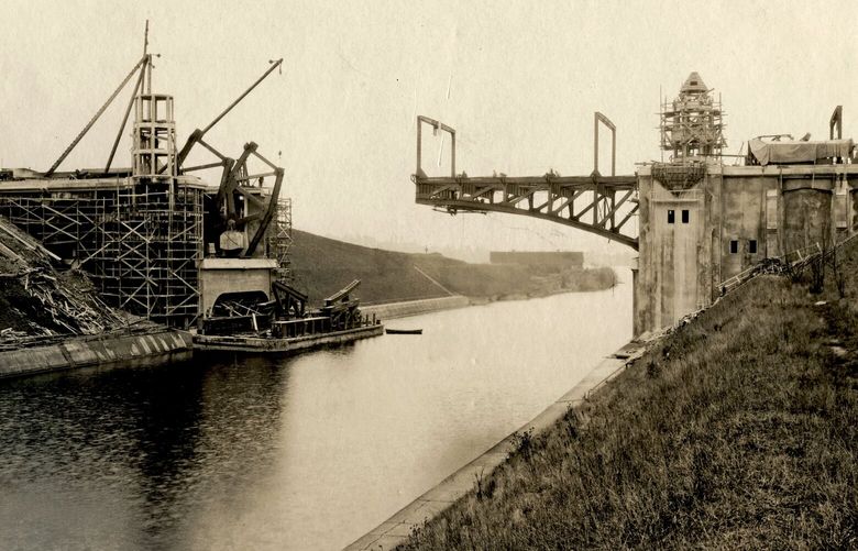 THEN: Just months before it opened, the double-leaf bascule Montlake Bridge is seen under construction on Feb. 6, 1925. Designed by the Seattle City Engineering Department, it measured 182 feet between trunnions, with a 68-foot-long reinforced concrete approach at either end.