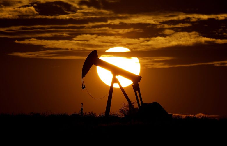 FILE – The sun sets behind an idle pump jack near Karnes City, USA, April 8, 2020.  Oil markets have been fluctuating over fears of lost supplies from Russia because of the war in Ukraine. But the alliance of OPEC members and allied oil-producing countries are likely to steer a steady course when they decide production levels at an online meeting Thursday. The OPEC+ alliance has been opening the taps only gradually to restore cuts made during the worst of the pandemic recession. (AP Photo/Eric Gay, File)