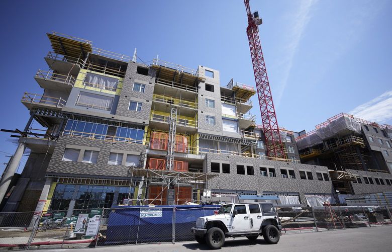A crane stands over a residential construction project on Sunday, April 23, 2023, in downtown Denver. On Thursday, the Commerce Department issues its first of three estimates of how the U.S. economy performed in the first quarter of 2023. (AP Photo/David Zalubowski) 