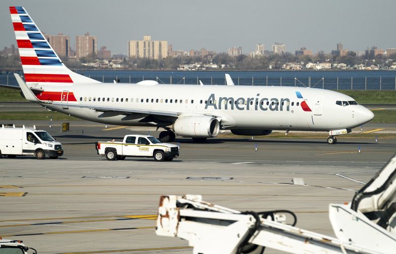 FILE – An American Airlines plane at LaGuardia Airport’s Terminal B, Tuesday, Nov. 22, 2022, in New York.  American Airlines reports earnings on Thursday, April 27, 2023. (AP Photo/Julia Nikhinson) NYBZ451 NYBZ451
