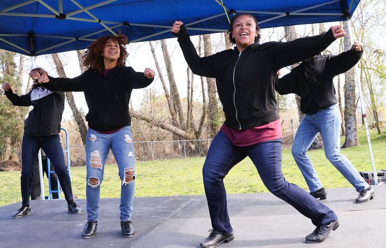 Teens from left to right: Denasia Gordon, 16, Amaya Brazil,15 ,Moniah Gabriel, 16, and Jocelyn McMillion, 14, from the The Youth Tap Ensemble from the Northwest Tap Connection perform at Be-er Sheva Park in Rainier Beach in Seattle on Saturday, April 1, 2023. The teens have been dancing around six years together. They practice three times a week for about two hours. “We are a racial, social justice oriented studio,” they say.