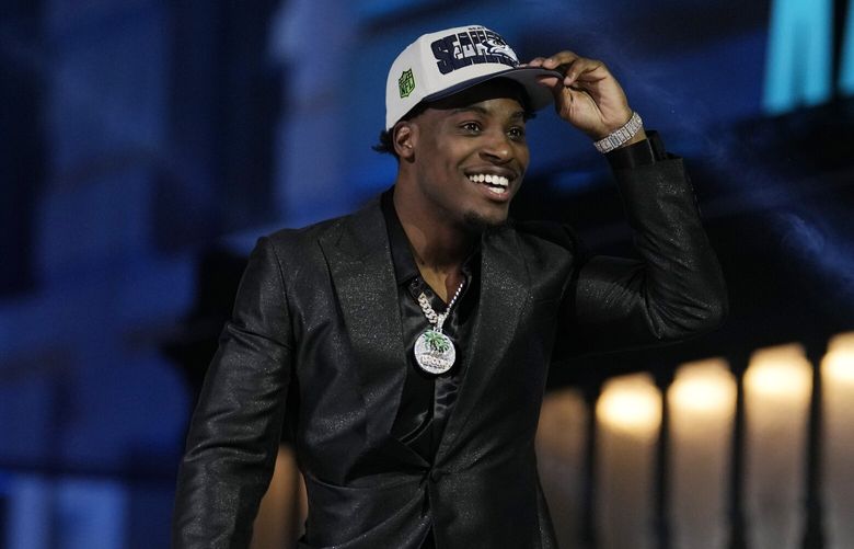 Illinois defensive back Devon Witherspoon reacts after after being chosen by the Seattle Seahawks with the fifth overall pick during the first round of the NFL football draft, Thursday, April 27, 2023, in Kansas City, Mo. (AP Photo/Jeff Roberson)