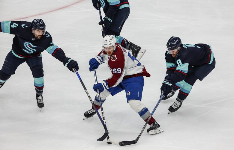 The Kraken team up to thwart Ben Meyers on the first period attack. 223684