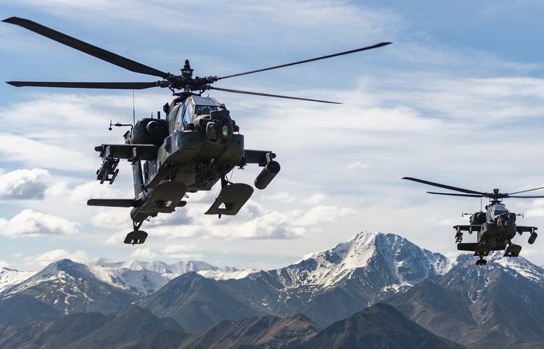 In this photo released by the U.S. Army, AH-64D Apache Longbow attack helicopters from the 1st Attack Battalion, 25th Aviation Regiment, fly over a mountain range near Fort Wainwright, Alaska, on June 3, 2019. The U.S. Army says two Army helicopters similar to the ones in this picture crashed Thursday, April 27, 2023, near Healy, Alaska, killing three soldiers and injuring a fourth. The helicopters were returning from a training flight to Fort Wainwright, based near Fairbanks. (Cameron Roxberry/U.S. Army via AP) FX504 FX504