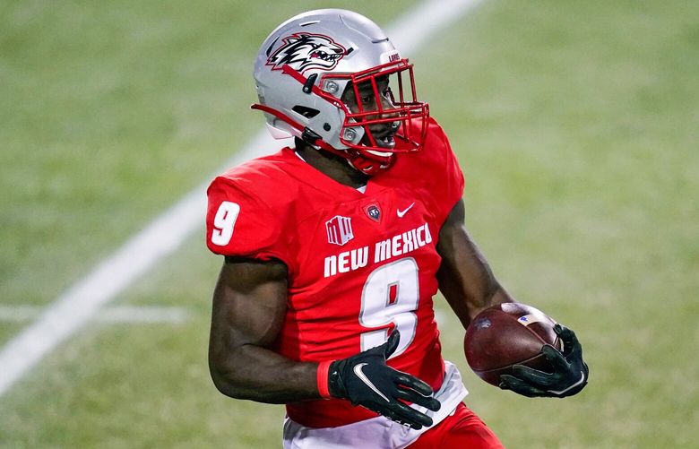 New Mexico safety Jerrick Reed II (9) runs with the ball after making an interception against Nevada during the first half of an NCAA college football game Saturday, Nov. 14, 2020, in Las Vegas. (AP Photo/John Locher) NVJL121