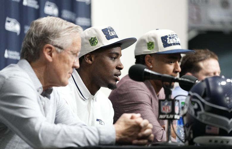 Seattle Seahawks first-round NFL football draft pick Devon Witherspoon, second from left, speaks during a news conference with head coach Pete Carroll, left, and fellow first-round pick Jaxon Smith-Njigba, third from left, Friday, April 28, 2023, at the team’s headquarters in Renton, Wash. (AP Photo/Lindsey Wasson) WALW118 WALW118