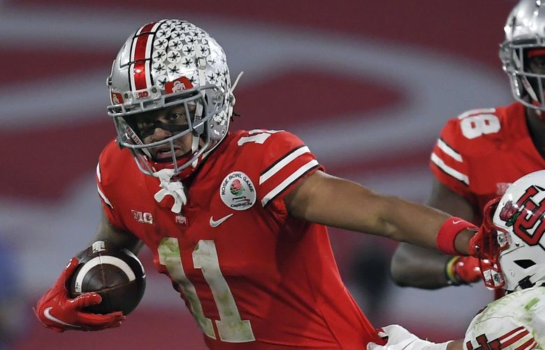 FILE â€” Ohio State wide receiver Jaxon Smith-Njigba (11) runs past Utah cornerback Kenzel Lawler (2) during the second half in the Rose Bowl NCAA college football game, Jan. 1, 2022, in Pasadena, Calif. Nine months later, the sting of losing to Michigan is still fresh for Ohio State. â€œIt was sickening,â€ Ohio State receiver Jaxon Smith-Njigba said of the 42-27 thumping Nov. 27 in Ann Arbor that ended an eight-game Buckeyes winning streak in the rivalry game. (AP Photo/John McCoy, File)