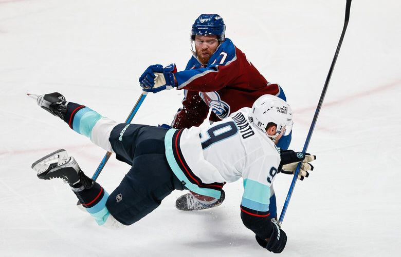 Colorado Avalanche left wing J.T. Compher trips up Seattle Kraken center Ryan Donato after Donato took a shot during the first period. 223708