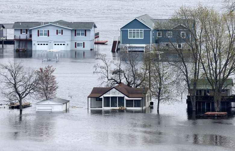 The flooded Mississippi River surrounds the homes on Abel Island near Guttenberg, Iowa, on Tuesday, April 25, 2023. (Stephen Gassman/Telegraph Herald via AP)