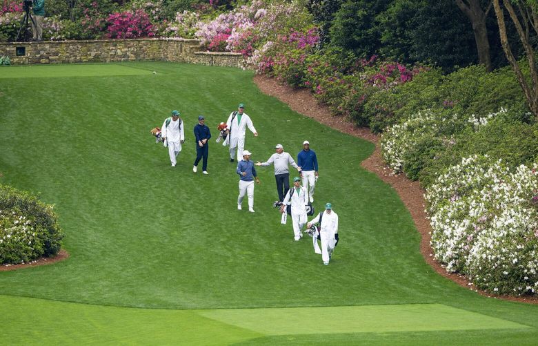 Caddies and golfers, including Rory McIlroy, second from left; Tom Kim, center left; Fred Couples, center; and Tiger Woods, center far right, on the new hill on the lengthened 13th hole during a practice round at Augusta National Golf Club in Augusta, Ga., April, 3, 2023. The course at Augusta National, now about 600 yards longer than it was 30 years ago, is like a living entity, growing and shifting regularly. (Doug Mills/The New York Times) XNYT133 XNYT133