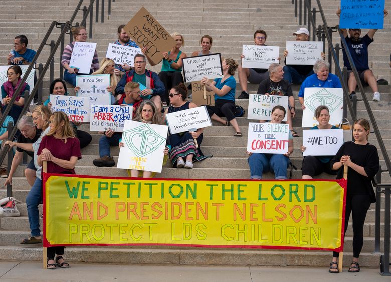 Protesters gather on the steps of the Utah State Capitol, at a rally to gain support for removing the clergy exemption from mandatory reporting in cases of abuse and neglect, on Aug. 19, 2022, in Salt Lake City. In a ruling made public Tuesday, April 11, 2023, the Arizona Supreme Court has ruled that the Church of Jesus Christ of Latter-day Saints can refuse to answer questions or turn over documents under a state law that exempts religious officials from having to report child sex abuse if they learn of the crime during a confessional setting. (Rick Egan/The Salt Lake Tribune via AP, File)