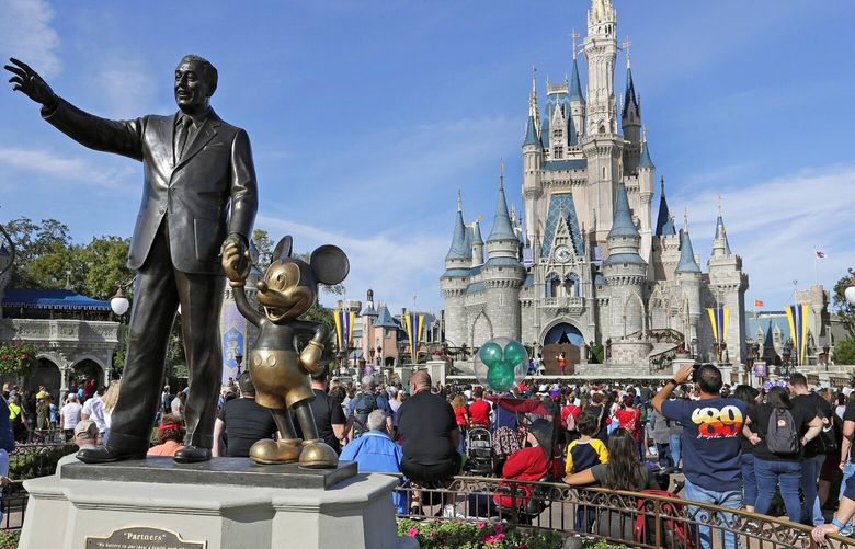 FILE – In this Jan. 9, 2019 photo, a statue of Walt Disney and Micky Mouse stands in front of the Cinderella Castle at the Magic Kingdom at Walt Disney World in Lake Buena Vista, Fla. The Walt Disney Co. will be laying off several thousand employees in the week starting Monday, April 24, 2023, a second round of cuts that’s part of a previously announced plan to eliminate 7,000 jobs this year. (AP Photo/John Raoux) NYBZ351 NYBZ351