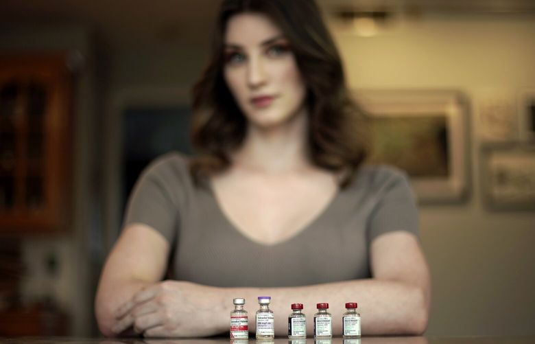 Transgender woman Stacy Cay displays some of the hormone therapy drugs she has stockpiled in fear of losing her supply, Thursday, April 20, 2023, at her home in Overland Park, Kan. (AP Photo/Charlie Riedel) KSCR104 KSCR104