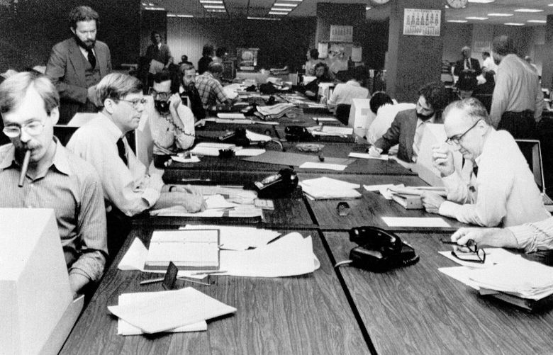**  FILE ** The newsroom at the New York Times is seen as editorial staffers work feverishly to prepare a Monday edition, in this Nov. 5, 1978 file photo. A reader-submitted question related to how newsrooms are alerted to breaking news stories is being answered as part of an Associated Press Q&A column called “Ask AP.” (AP Photo/Ron Frehm, File)