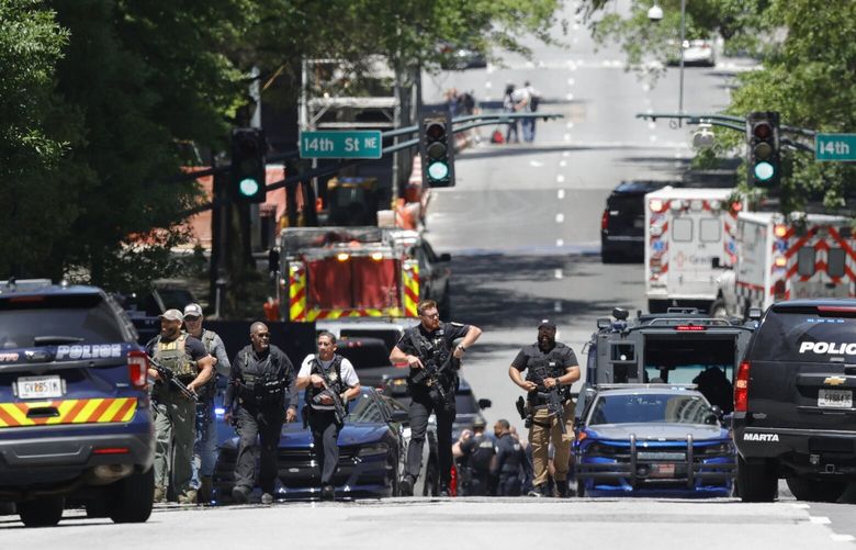 Law enforcement officers stage near the scene of an active shooter on Wednesday, May 3, 2023 in Atlanta. Atlanta police said there had been no additional shots fired since the initial shooting unfolded inside a building in a commercial area with many office towers and high-rise apartments.   (AP Photo/Alex Slitz) GAAS102 GAAS102