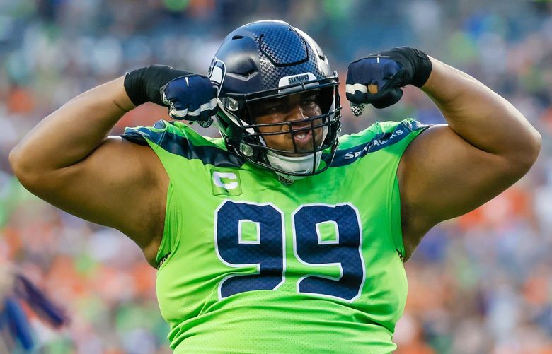 Seattle Seahawks defensive tackle Al Woods flexes after the Denver Broncos fumbled the ball near the goal line during the third quarter Monday, Sept. 12, 2022, in Seattle. 221558