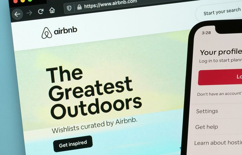 FILE – The login page for Airbnb’s iPhone app is seen in front of a computer displaying Airbnb’s website on May 8, 2021, in Washington. Airbnb is going back to its roots to cater to travelers who are growing more concerned with saving money. The company said Wednesday, May 3, 2023, that it’s rolling out a new Airbnb Rooms offering in which guests share space with the owner. Airbnb says room prices will average $67 a night. (AP Photo/Patrick Semansky, File) NYWS301 NYWS301