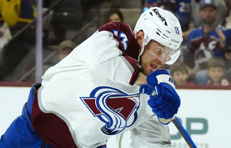 Colorado Avalanche right wing Valeri Nichushkin gets off a shot against the Arizona Coyotes during the first period of an NHL hockey game Sunday, March 26, 2023, in Tempe, Ariz. (AP Photo/Ross D. Franklin)