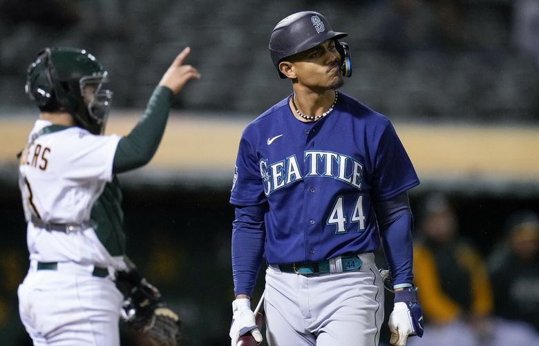 Seattle Mariners’ Julio Rodríguez, right, reacts after striking out against the Oakland Athletics during the third inning of a baseball game in Oakland, Calif., Wednesday, May 3, 2023. (AP Photo/Godofredo A. Vásquez) OAS109 OAS109