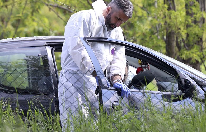Forensic police operates on a car in the village of Dubona, some 50 kilometers (30 miles) south of Belgrade, Serbia, Friday, May 5, 2023. A shooter killed multiple people and wounded more in a drive-by attack late Thursday in Serbia’s second such mass killing in two days, state television reported. (AP Photo/Armin Durgut) XAD118 XAD118