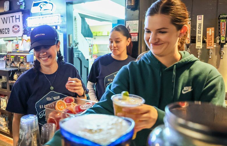 Aly Snyder, left, Virginia Valdovinos and Maddie Flood tend bar Thursday evening at The Dock Sports Bar & Grill in Fremont neighborhood of Seattle, Washington on May 4, 2023.