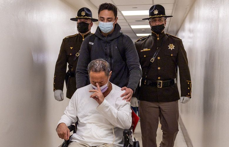 David Easterly, a 25-year veteran of the King County Sheriff’s Office and pushed by his son Chance Easterly makes their way through the halls of Harborview Medical Center Friday morning in Seattle, Washington on May 15, 2023.