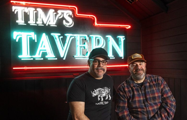 Tim’s Tavern owners Mason Reed (l) and Matt O’Toole sit in front of their neon sign hanging at the Seattle Legends stage in their new neighborhood bar/music venue, Tim’s Tavern located in White Center Thursday, March 23, 2023. .
After closing its Greenwood spot in 2021, Tim’s Tavern has found a new home in White Center, taking over a former Drunky’s BBQ location. They’re keeping the outdoor stage and Airstream trailer bar where they will have live music and dogs are welcome. 223372