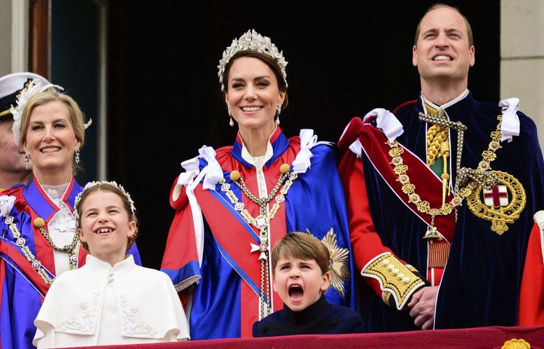 Sophie, Duchess of Edinburgh, left, Kate, Princess of Wales, centre, Prince William, right, stand on the balcony of Buckingham Palace with Princess Charlotte, down left, and Prince Louis, down centre, during the coronation of Britain’s King Charles III, in London, Saturday, May 6, 2023. (Leon Neal/Pool Photo via AP) ELO227 ELO227