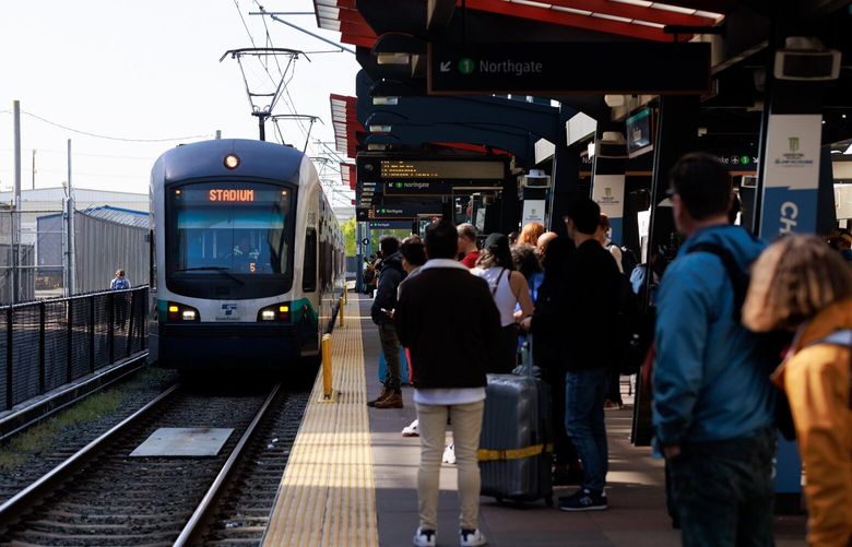 Crowds congregate at the Stadium Station light-rail station in Seattle Friday, April 28, 2023. 223701