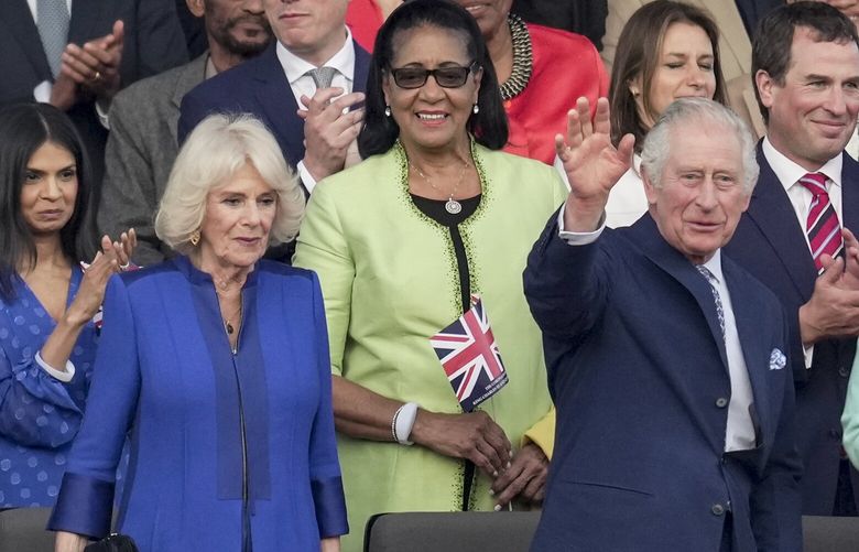 King Charles III, flanked by Queen Camilla, waves from the Royal Box during a concert at Windsor Castle in Windsor, England, Sunday, May 7, 2023, celebrating the coronation of King Charles III. It’s one of several events over a three-day weekend of celebrations. (AP Photo/Kin Cheung, Pool) FP139 FP139