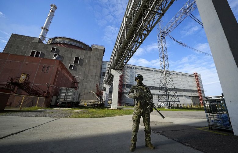 FILE – A Russian serviceman guards in an area of the Zaporizhzhia Nuclear Power Station in territory under Russian military control, southeastern Ukraine, May 1, 2022. The head of the United Nations’ nuclear watchdog Rafael Grossi is expressing growing anxiety about the safety of the Zaporizhzhia Nuclear Power Plant, after the governor of the Russia-occupied area ordered the evacuation of a town where most plant staff live amid ongoing attacks in the area.  (AP Photo/File) LBJ101 LBJ101