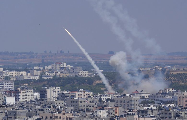 Rockets are launched from the Gaza Strip towards Israel, in Gaza City, Wednesday, May 10, 2023. Israeli aircraft struck targets in the Gaza Strip for a second straight day on Wednesday, killing at least one Palestinian and pushing the region closer toward a new round of heavy fighting. (AP Photo/Adel Hana) XOB106 XOB106