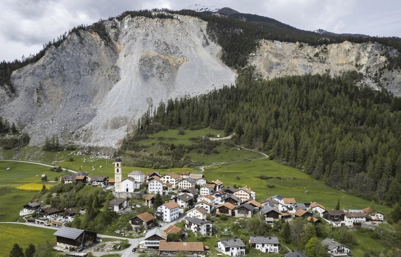 View of the village and the “Brienzer Rutsch”, taken on Tuesday, 9 May 2023, in Brienz-Brinzauls, Switzerland. Authorities in eastern Switzerland have ordered residents of the tiny village of Brienz to evacuate by Friday evening because geology experts say a mass of 2 million cubic meters of Alpine rock looming overhead could break loose and spill down in coming weeks. (Gian Ehrenzeller/Keystone via AP) BRI802 BRI802