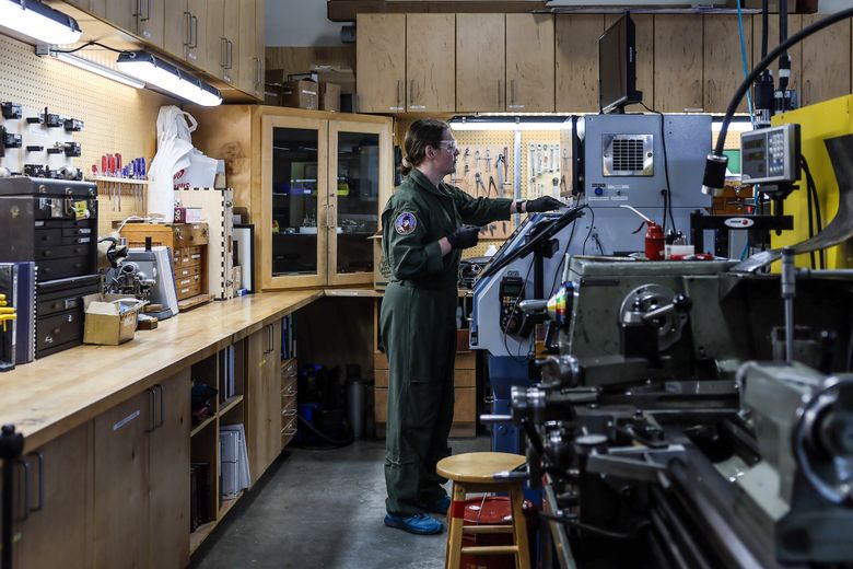 Eli Backer cleans in BARN&#8217;s machine shop. (Kevin Clark / The Seattle Times)