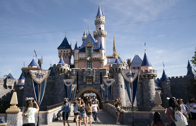 FILE – Visitors pass through Disneyland in Anaheim, Calif., on April 30, 2021.  (AP Photo/Jae C. Hong, File)