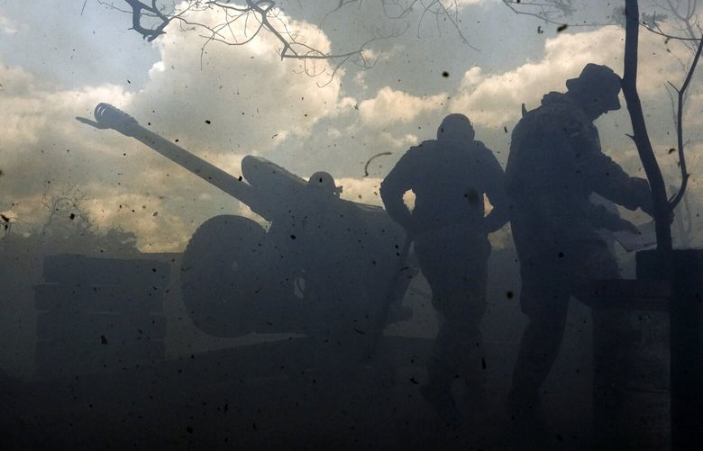 Ukrainian soldiers fire a cannon near Bakhmut, an eastern city where fierce battles against Russian forces have been taking place, in the Donetsk region, Ukraine, Friday, May 12, 2023. (AP Photo/Libkos) XEL128 XEL128