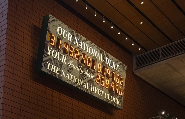 The National Debt Clock in Manhattan, May 4, 2023. Stocks aren’t showing signs of panic about the government’s ability to pay its bills, but there are signs of anxiety creeping into other markets. (Hiroko Masuike/The New York Times) XNYT75 XNYT75