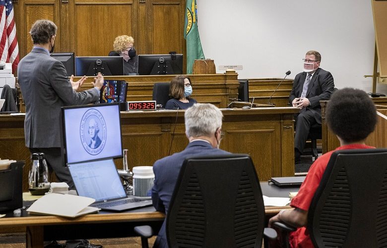Senior deputy prosecuting attorney William Doyle (l) questions Seattle Police Department homicide detective Don Witmer on the witness stand regarding a fatal shooting in the Westlake station transit tunnel in King County Superior Court Judge Janet Helsonís courtroom  Wednesday, May 4, 2022.   220293