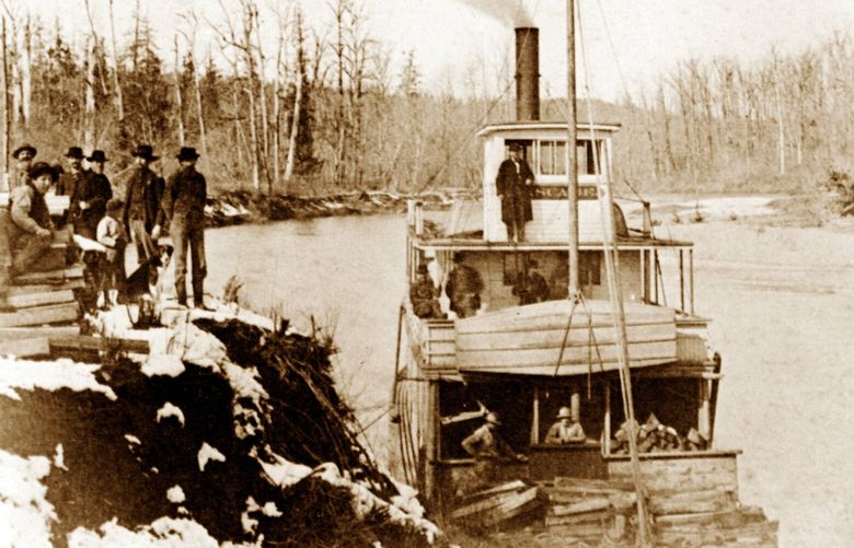 THEN: In this snowy scene in winter 1888, the steamboat Cascade, piloted by Captain George W. Gove, stops along the Snoqualmie River at The Landing, later renamed Fall City, next to today’s state Highway 202. Hauling hops from nearby farms, it also picked up stacked 4-foot cordwood. This is the cover photo for “Steamboats on the Snoqualmie.” Built in 1884, the Cascade last operated in 1901. Visible onshore with a dog is 8-year-old Albert Moore, later a farmer and North Bend Timber fire warden.
